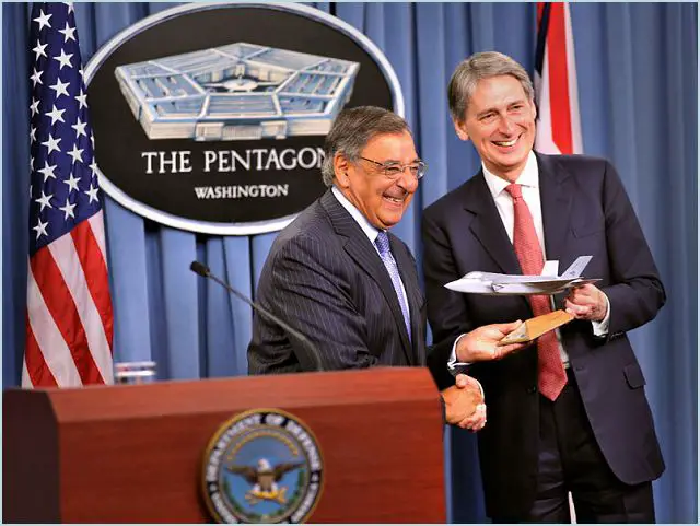 US Secretary of Defense Leon Panetta hands over a model of the F-35 Lightning II to UK Defence Secretary Philip Hammond at the Pentagon yesterday, 18 July, symbolically marking today's delivery of the first Lightning II jet to British forces