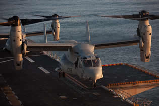 Produced by two major manufacturers Bell and Boeing, the V-22 Osprey is a joint service multi-role combat aircraft utilizing tiltrotor technology to combine the vertical performance of a helicopter with the speed and range of a fixed wing aircraft. With its engine nacelles and rotors in vertical position, it can take off, land and hover like a helicopter. Once airborne, its engine nacelles can be rotated to convert the aircraft to a turboprop airplane capable of high-speed, high-altitude flight.